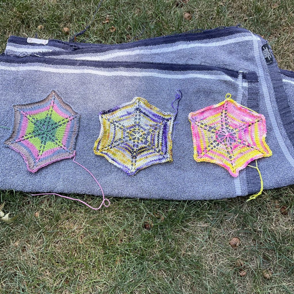 three knit hexagons laying flat to dry not in direct sun