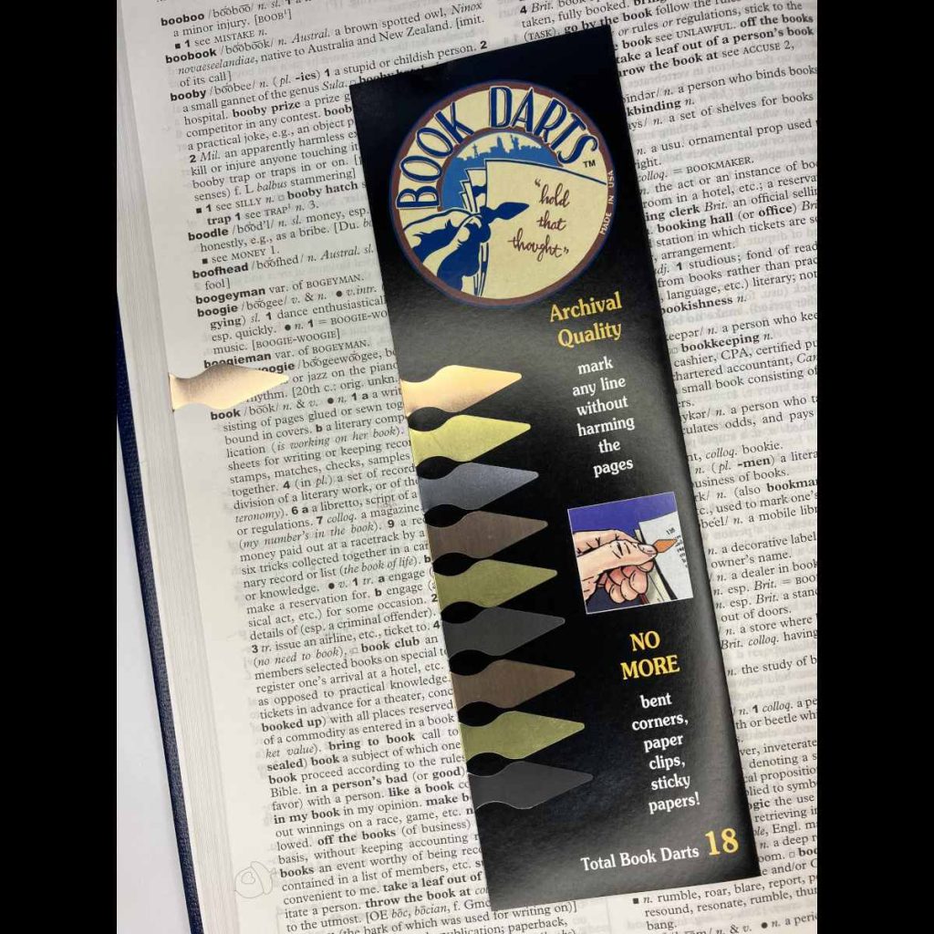 front of sleeve of book darts on a dictionary page for "book"