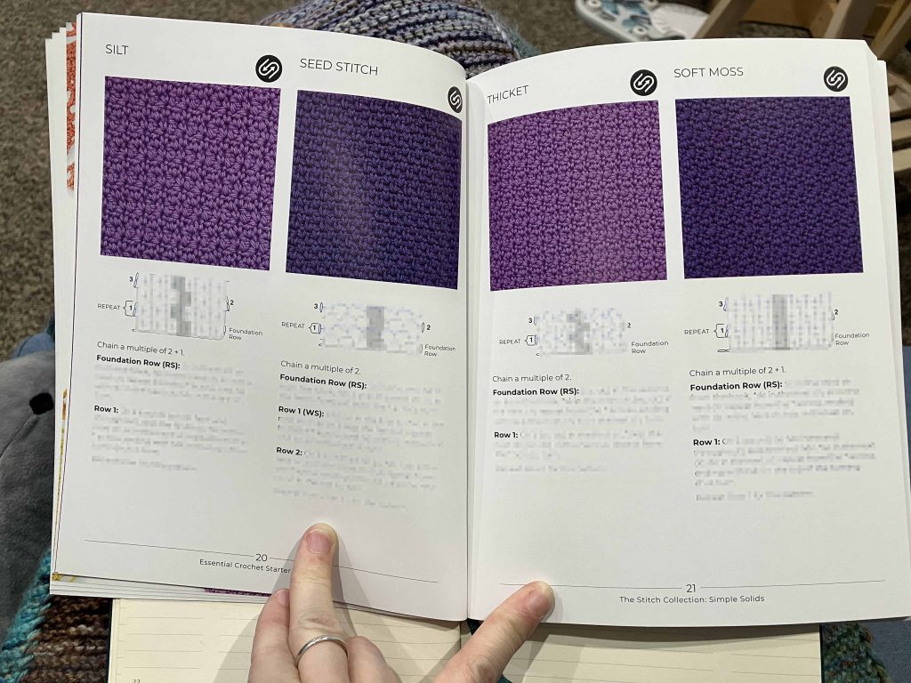 person holding a book open. showing 4 crochet stitches worked in purple yarns. Some of the text and stitch diagram is intentionally distorted.