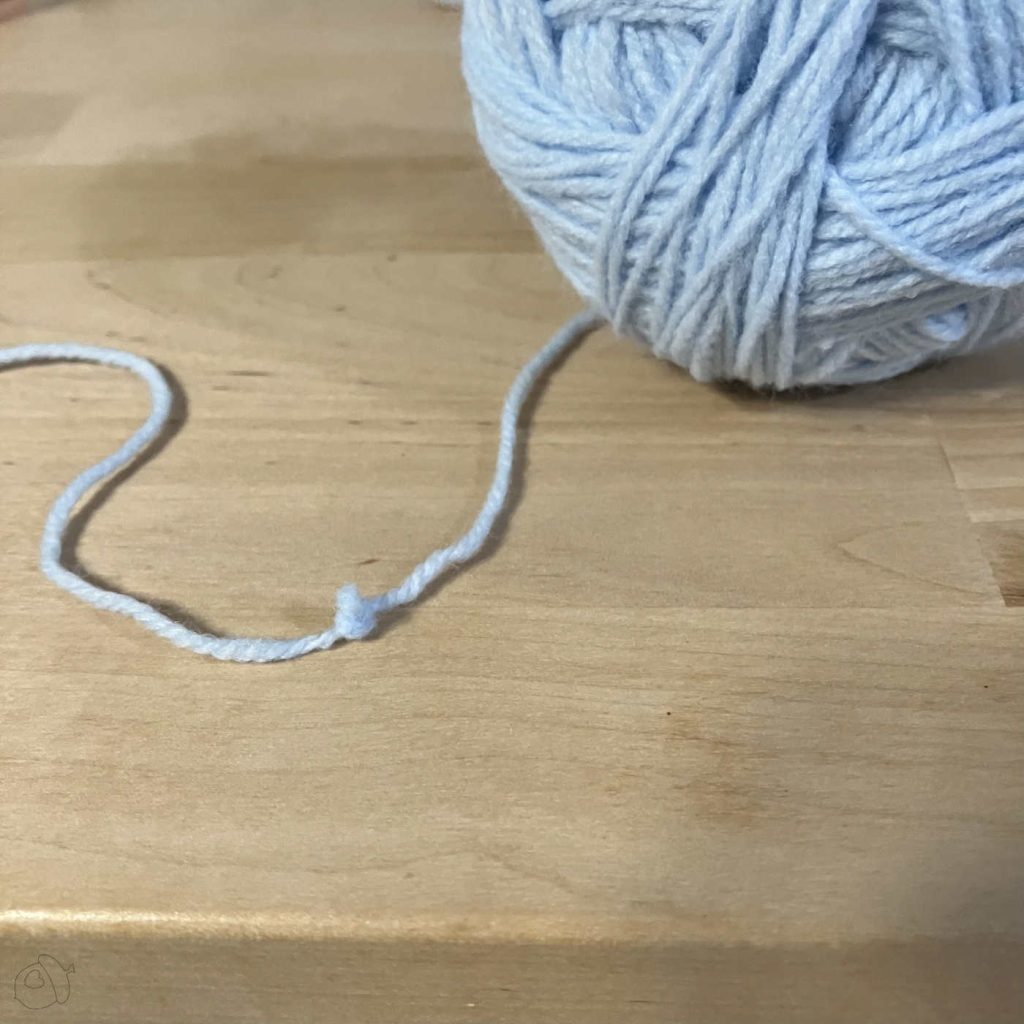 knot in pale blue yarn discovered while winding